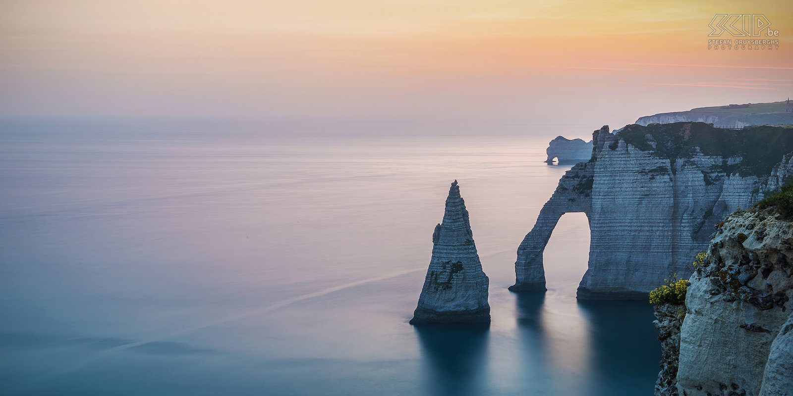 Normandy - Sunrise Étretat Early sunrise with lovely soft licht at the wonderful cliffs of Étretat. In the front you can see the arch Porte d'Aval and the pointed 'needle' and in the back the arch Porte d'Amont. Stefan Cruysberghs